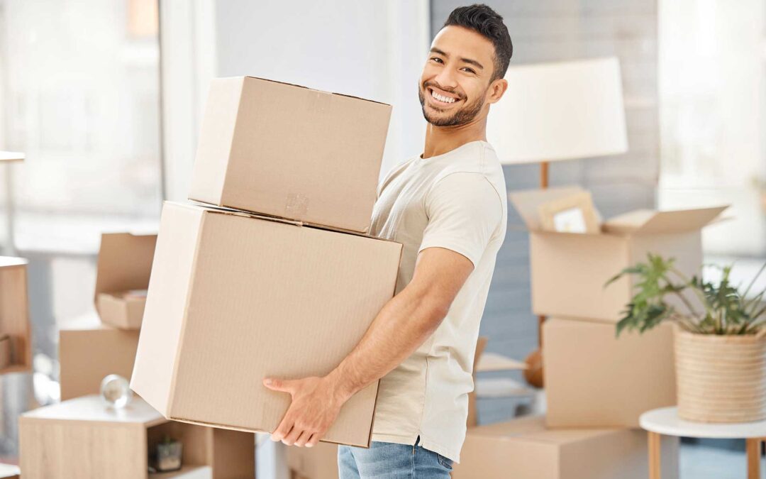 Man moving into a new home, carrying boxes